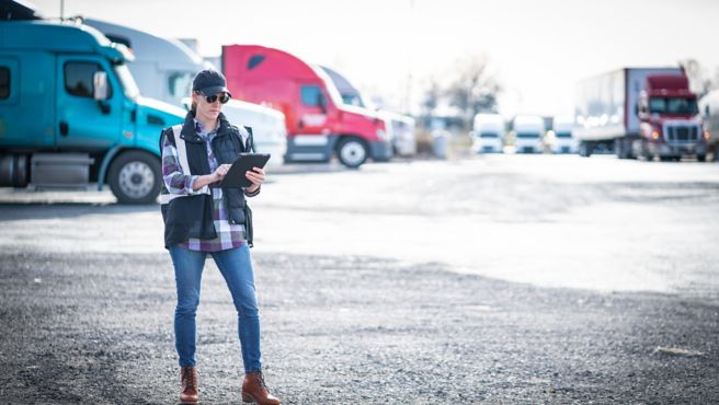 Driver near fleet of trucks